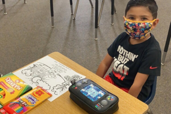 School child wearing face mask in the classroom 2020