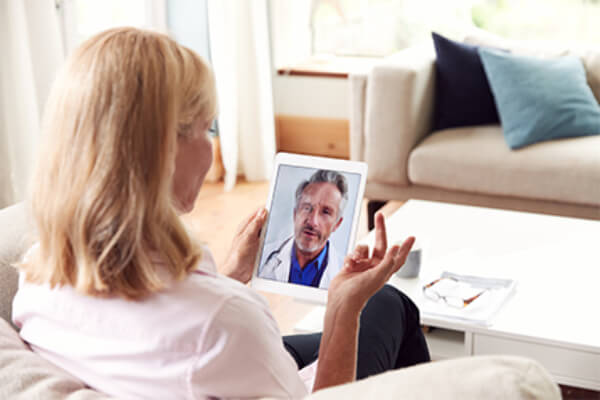 Female patient using video chat telehealth app for doctor visit 
