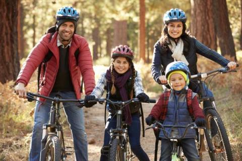 Family rides bikes in the fall