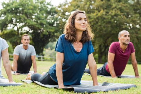 woman on yoga mat exercising as a natural way to lower hypertension