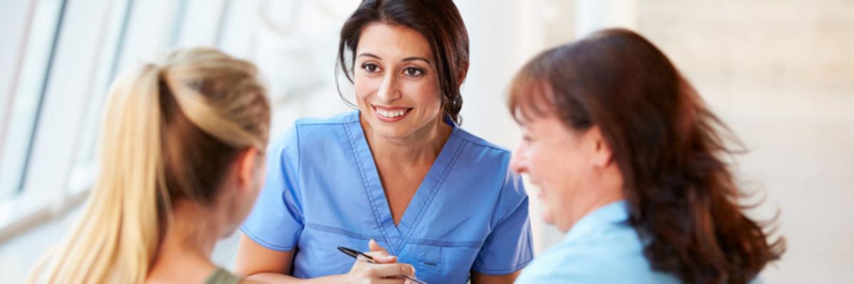 Young nurse or doctor talking with young woman and mature woman, career concept, interview concept