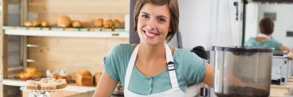 Young adult woman wearing an apron in a bakery, Occupational Health